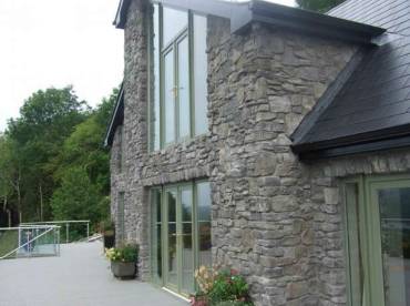 French doors and balcony clad with the Highland Stone Blue profile